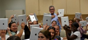 FIU teachers holding up their new iPads.
