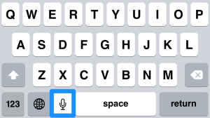 Microphone icon to left of space bar activates Dictation in iOS.